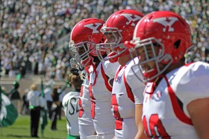 Youngstown State captains walk onto Spartan Stadium for the coin toss before kickoff of Saturday’s matchup against Michigan State. The Penguins lost to the Spartans 55-17, dropping their record to 2-1. Photo by Dustin Livesay/The Jambar.