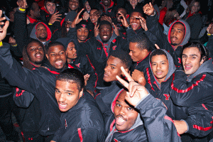 The Youngstown State University football team  celebrates during the Fall Fire Fest pep rally on Thursday night. The Penguins take a 7-1 record into  a bye week before traveling to the University of South Dakota.  Photo by Dustin Livesay/ The Jambar.