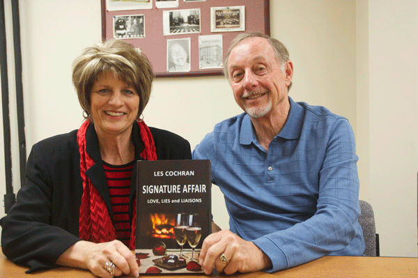 Former YSU President Leslie Cochran and Lin Cochran, his wife, display  Leslie Cochran’s new novel “Signature Affair: Love, Lies and Liason.” Their trip to Youngstown is part of an effort to promote the novel. Photo by Frank George/ The Jambar.
