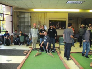 Corey Runyan, Kevin Sergeff, Michael Sammarco and Dylan Marketich pose with their miniature golf course in Moser Hall. Photo courtesy of Kerry Meyers.
