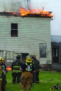 Cadets watch a controlled fire on Ford Street on Friday as part of an exercise run by the Youngstown Fire Department. The cadets are finishing their fire certification course and are looking to join local fire departments. 