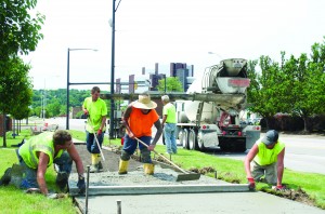 A fresh batch of concrete is smoothed outside Beeghly Hall in preparation for the fall semester. 