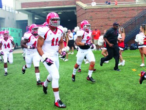 Derek Rivers (11) runs with his teammates onto the field for the season opener against Illinois at the University of Illinois on Aug. 30. 