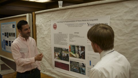 Yener Ulus, a third semester biology graduate student, showcases his research on phytore-mediation of heavy metals. Photo by Frank George/ The Jambar. 