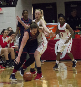 Youngstown State University forward Sarah Cash prevents a University of Illinois at Chicago player from driving to the basket.