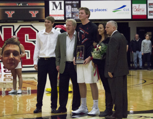 Youngstown State University forward Bobby Hain is honored by his family and head coach Jerry Slocum before the game.