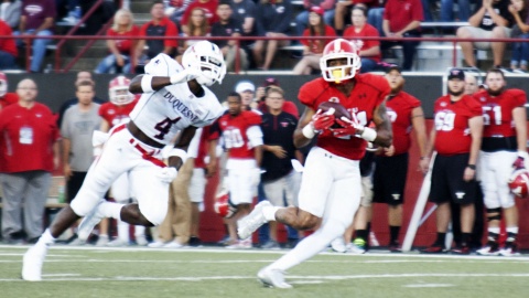 Youngstown State University wide receiver Darien Townsend (21) makes and over the shoulder catch in front of Duquesne University defensive back Daquan Worley (4).