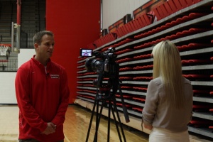 John Barnes, head coach of the Youngstown State University women's basketball team, conducts an interview during media day.