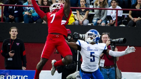 Kenny Bishop (7), defensive back for Youngstown State University, jumps in front of Clayton Smith (5), receiver for Indiana State University, to break up a pass down the field.