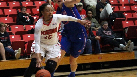 Youngstown State University guard Mailee Jones (10) drives past an American University defender as she drives to the basket.
