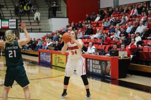 Morgan Brunner (34) hits a 3 over the top of Jessica Lindstrom (21).