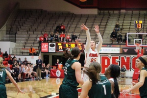 Morgan Olson (25) shoots over the top of multiple Cleveland State defenders.