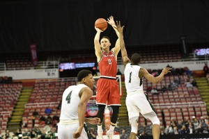 Matt Donlan (0) shoots a 3-pointer over Kenny Carpenter (1) and Anthony Wright (4) in YSU’s First Round win. 
